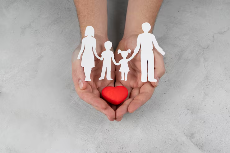 hands-holding-paper-people-heart-close-up